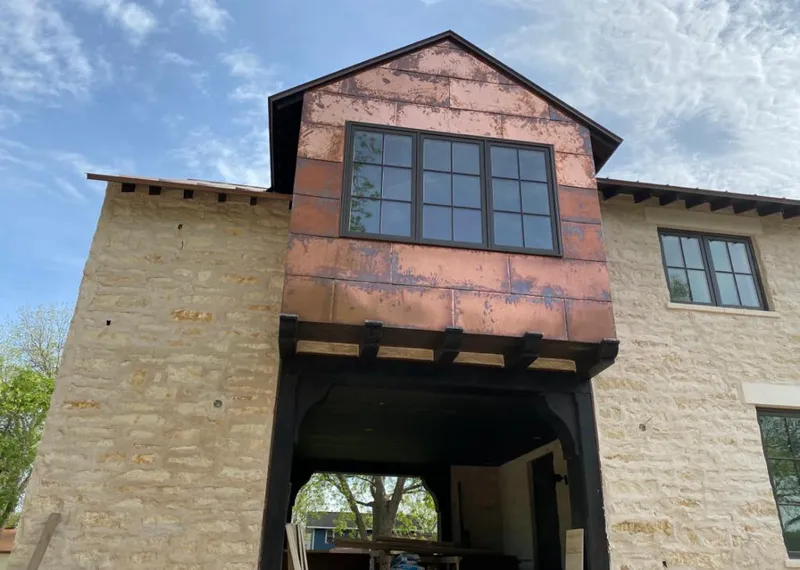 Copper metal panel facade on a stone building for Roof Repair in Cape Coral